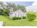 This single-Gathering home features a well-maintained lawn and charming curb appeal at 6304 Kendra Ln, Lithonia, GA 30058