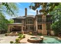 Stunning home exterior showcasing a pool, hot tub, and covered patio area at 1640 Nottingham Ne Way, Atlanta, GA 30309