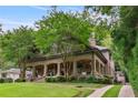 Charming brick home with covered porch, well-maintained lawn, and a curved driveway at 1640 Nottingham Ne Way, Atlanta, GA 30309