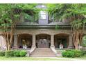 Elegant front porch with brick columns, stone steps, and meticulously maintained landscaping at 1640 Nottingham Ne Way, Atlanta, GA 30309
