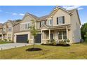 Charming two-story home with a two-car garage, covered front porch, and landscaped yard at 116 Eleanora Park, Loganville, GA 30052