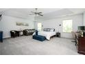 Spacious main bedroom with tray ceilings, a sitting area, ample natural light, and carpeted floors at 319 Nobleman Way, Canton, GA 30114