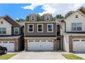 Beautiful townhome showcasing a two-car garage and attractive curb appeal in a desirable community at 7805 Rock Rose Ln, Fairburn, GA 30213