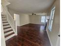 Inviting living room with hardwood floors, a fireplace, and staircase at 1857 Oak Hill Springs Blvd, Lithonia, GA 30058