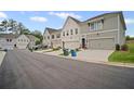 Street view featuring townhome exteriors with attached garages and landscaping at 1914 Carovel Way, Kennesaw, GA 30144