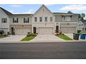 Townhome exteriors feature varied colors, brick accents, driveways, and attached garages at 1914 Carovel Way, Kennesaw, GA 30144