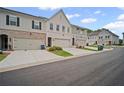 Neighborhood street view showcasing townhome exteriors and attached garages at 1914 Carovel Way, Kennesaw, GA 30144