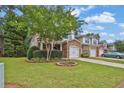 Exterior view of a two-story townhome with brick accents and a well-manicured lawn at 3461 Dianthus Ln, Lawrenceville, GA 30044