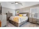 Comfortable bedroom with neutral walls, a ceiling fan, a large bed, and side tables with lamps at 406 Genevieve Dr, Canton, GA 30114