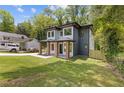 Charming two-story home with landscaped yard, brick accents, modern design, and lush green trees at 2060 North Avenue Nw, Atlanta, GA 30318