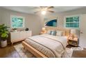 Bright, staged bedroom with large bed, modern furniture, and natural light at 2584 Favor Sw Rd, Marietta, GA 30060