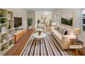 Bright, staged living room featuring a sofa, armchair, rug, and decorative plants at 2584 Favor Sw Rd, Marietta, GA 30060