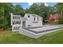 A modern home with a landscaped yard featuring decorative rock and lush green grass at 2683 Tritt Springs Ne Trce, Marietta, GA 30062