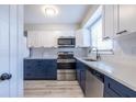 Modern kitchen with two-tone cabinetry, stainless steel appliances, and stylish fixtures at 6700 Roswell Rd # 21E, Sandy Springs, GA 30328