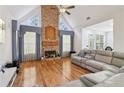 Cozy living room with stone fireplace, hardwood floors, and ample natural light at 3223 Thornecreek Dr, Douglasville, GA 30135