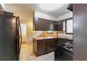 Kitchen features classic appliances, dark cabinetry, and tile flooring, awaiting modern updates at 460 E Kildare Nw Ave, Atlanta, GA 30318