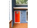 Vibrant red front door with a decorative window panel and modern hardware at 674 Crespan Ct, Lawrenceville, GA 30044