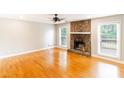 Spacious living room boasts a stone fireplace and gleaming hardwood floors at 674 Crespan Ct, Lawrenceville, GA 30044