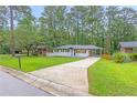 Beautifully landscaped front yard with a freshly painted home and long driveway at 2720 Cavalier Dr, Decatur, GA 30034
