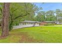 Inviting front yard with mature trees and lush grass, enhancing the curb appeal at 2720 Cavalier Dr, Decatur, GA 30034
