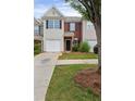Inviting townhouse with brick accents, lush landscaping, and a well-kept lawn, offering suburban charm at 359 Azalea Cir, Cumming, GA 30028