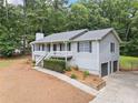 Lovely home with a fenced yard, a two car garage and professional landscaping at 5045 Shadow Wood Dr, Canton, GA 30114