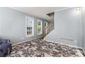 Cozy living room with lots of light, with a decorative rug and neutral paint at 4913 Farm Valley Ne Dr, Woodstock, GA 30188