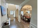 Inviting foyer with hardwood floors, arched doorways, and a view into the dining room at 719 Lilac Mist Dr, Loganville, GA 30052