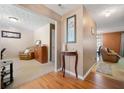 Inviting foyer with hardwood floors leading to carpeted living spaces, complemented by a decorative table and artwork at 1777 Cutters Mill Way, Lithonia, GA 30058