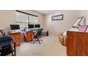Functional home office with a spacious desk setup, comfortable seating, and ample natural light from the window at 1777 Cutters Mill Way, Lithonia, GA 30058