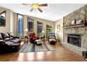 Inviting living room with a stone fireplace, hardwood floors, and abundant natural light at 3491 Birchwood Trl, Snellville, GA 30078