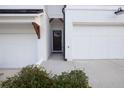 Shot of the entry area between garages leading to the black painted front door at 375 Auburn Valley Way, Auburn, GA 30011