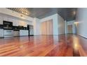 Open-concept living area with wood floors, modern lighting and kitchen with stainless steel appliances at 620 Glen Iris Ne Dr # 321, Atlanta, GA 30308