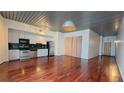 Open-concept living area with wood floors, modern lighting and kitchen with stainless steel appliances at 620 Glen Iris Ne Dr # 321, Atlanta, GA 30308