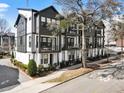Eye-catching three-story modern townhomes with black and white exteriors, landscaping and tree-lined street at 92 Rogers Ne St, Atlanta, GA 30317