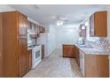Traditional kitchen with wood cabinetry, white appliances, and tile backsplash at 4307 Windward Ln, Norcross, GA 30093