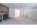 Spacious living room with stone fireplace and neutral carpeting, ideal for entertaining at 4307 Windward Ln, Norcross, GA 30093