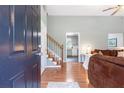 Bright entryway featuring hardwood floors, staircase, open access to the kitchen and living room at 7108 Hummingbird Ln, Winston, GA 30187