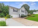Side view of a two-story house with a well-kept lawn, landscaping and driveway at 7108 Hummingbird Ln, Winston, GA 30187