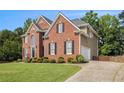 Beautiful brick home with a well-manicured lawn, attached garage, and private driveway at 1006 Kingsbridge Vw, Powder Springs, GA 30127