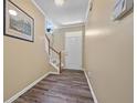 Inviting entryway with wood-look flooring, staircase, white front door, and neutral wall paint at 1414 Dolcetto Nw Trce # 14, Kennesaw, GA 30152