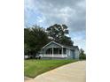 Attractive single-story home boasting a quaint front porch and green lawn at 2268 Newnan St, Atlanta, GA 30344