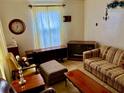 Living room displaying vintage furniture including a couch, end tables, an ottoman and a large television at 1968 Don Juan Ln, Decatur, GA 30032