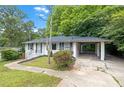 Home with a carport, white brick exterior, neat landscaping, and a walkway leading to the entrance at 2683 Rockcliff Se Rd, Atlanta, GA 30316