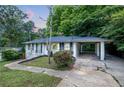 Home with a carport, white brick exterior, neat landscaping, and a walkway leading to the entrance at 2683 Rockcliff Se Rd, Atlanta, GA 30316