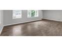 A bright living room showcasing stylish flooring, fresh paint, and ample natural light from large windows at 2683 Rockcliff Se Rd, Atlanta, GA 30316