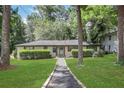 Attractive single-story home with well-manicured lawn and mature trees, offering great curb appeal at 3093 Del Monico Dr, Decatur, GA 30032