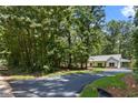 Charming single-story home surrounded by lush greenery with a newly paved driveway at Lot 2 Harmony Rd, Temple, GA 30179