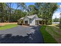 Beautiful single-story home featuring dark trim windows and a covered carport at Lot 2 Harmony Rd, Temple, GA 30179
