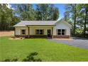 Beautiful single-story home with a well-manicured lawn, dark trim windows, and a welcoming front porch at Lot 2 Harmony Rd, Temple, GA 30179